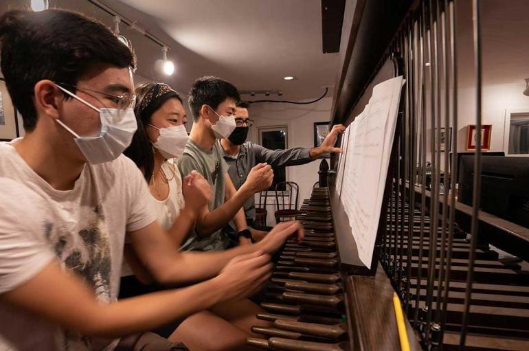 From left: Fourth-years João Francisco Shida, Emily Kim and Joseph Min practice for the inauguration with University Carillonneur Joey Brink on the carillon in the bell tower of Rockefeller Memorial Chapel.