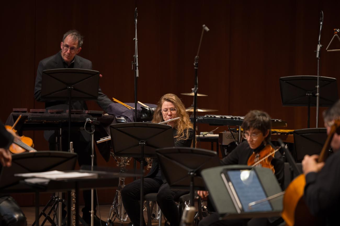 Grossman Ensemble percussionist, flutist, and violinist performing in concert