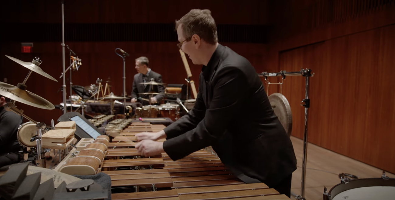 John Corkill playing marimba with Gregory Beyer playing percussion in the background