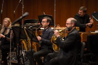 Katie Jimoh, Taimur Sullivan, and Matthew Oliphant perform on stage.