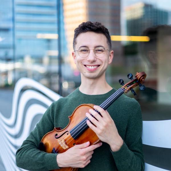 Theo Ramsey holding a violin